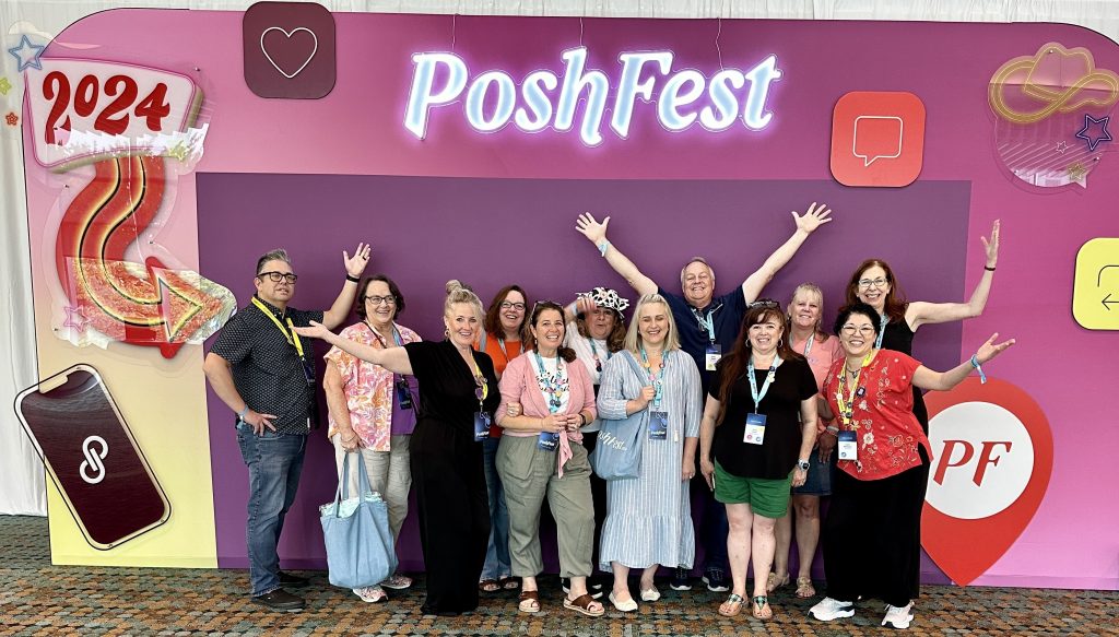 List Perfectly team and resellers posing together in front of the PoshFest 2024 backdrop