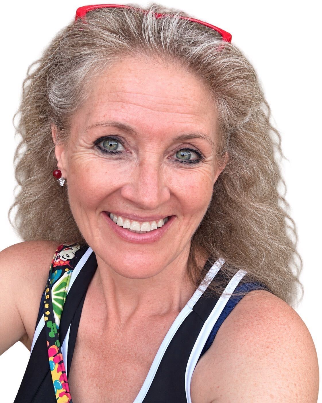 Trish Glenn smiling with red glasses resting on her head