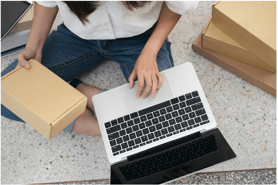 lady with package at laptop